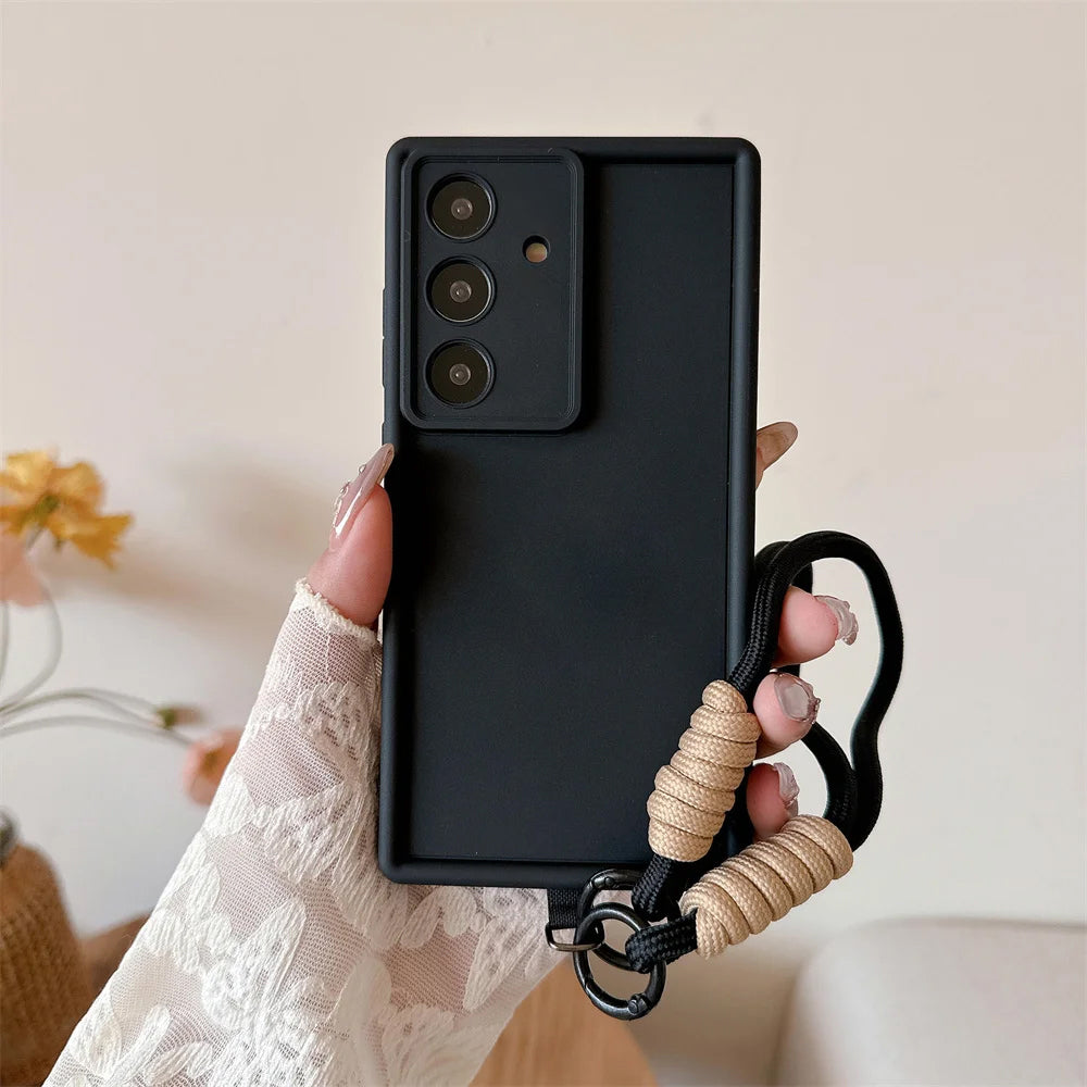 Black phone case with a lanyard held by a hand against a neutral background